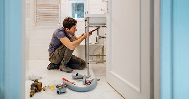 plumber fixing sink